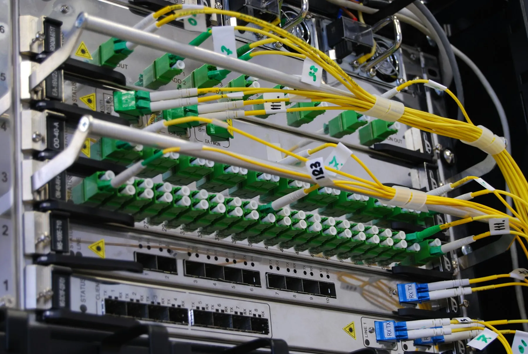 Fibre-optic cables connected to a network switch panel
